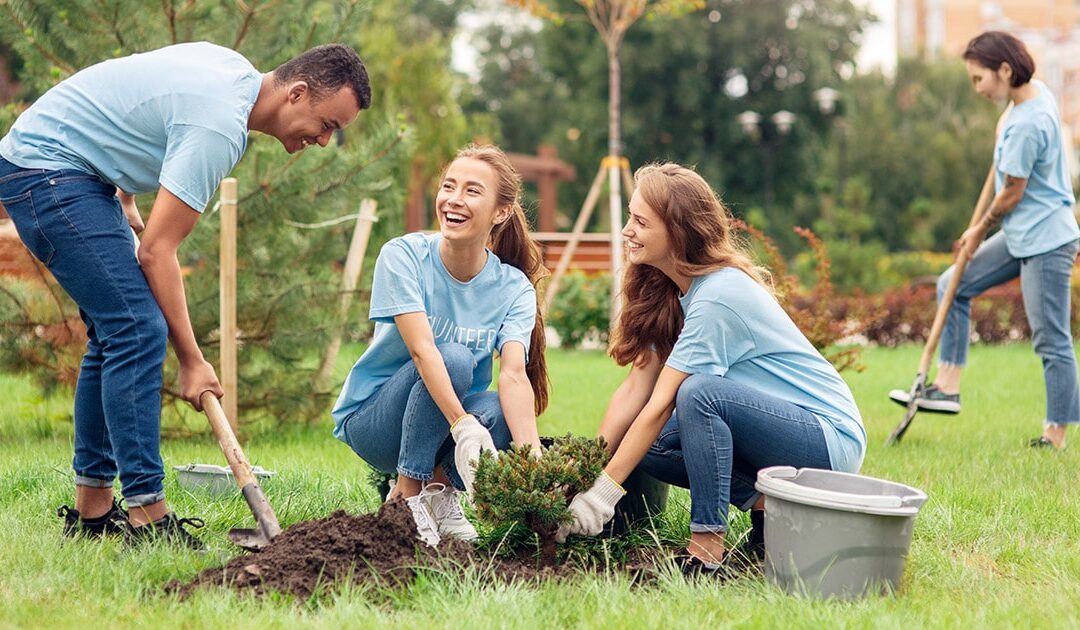 People smiling while working in a garden