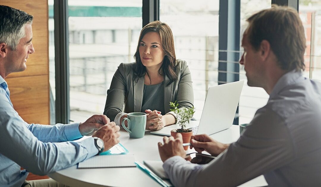 Three people in business attire talking - Leadership