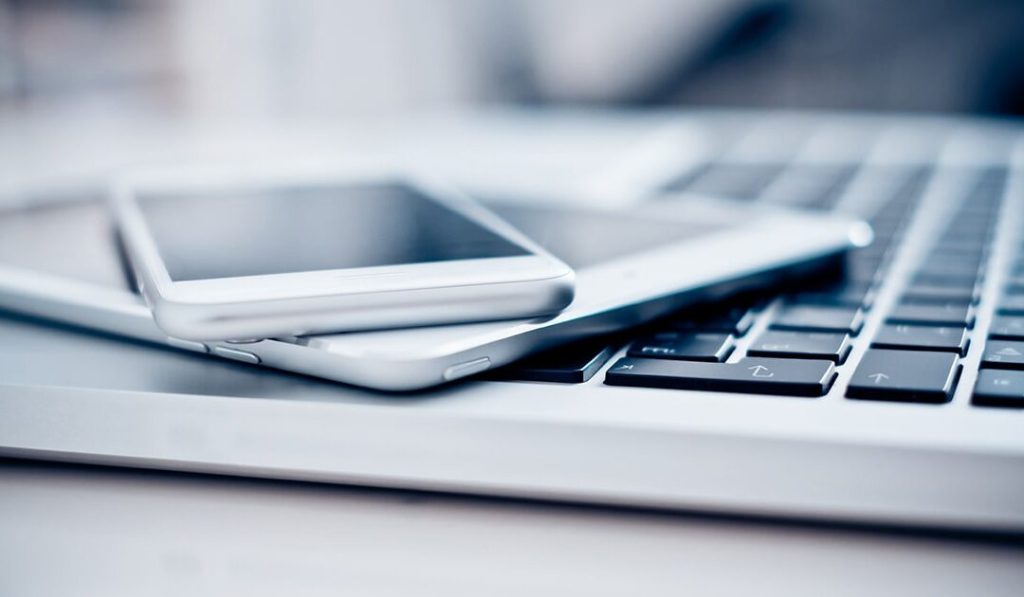 Phone and tablet on top of laptop - benefits of going tech-free for a day