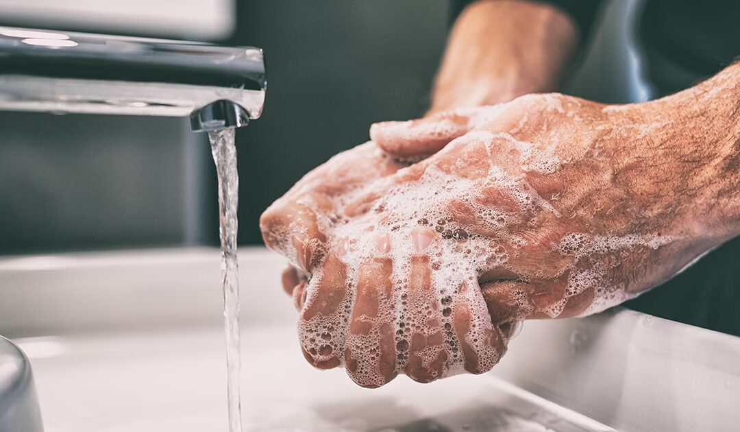 Person washing hands - Dial Gold Refill Jugs